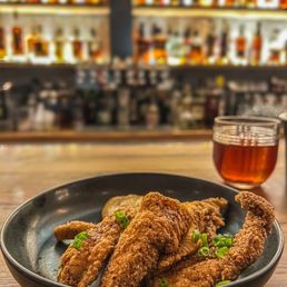 North of Bourbon signature dishes Peppered Catfish Nuggets, Oysters and Champagne, Chicken Wings, Shrimp and Grits.